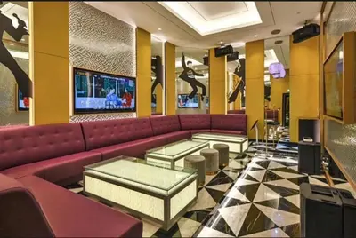 a lobby with a red couch and a tv at Star KLCC by homestay in Kuala Lumpur