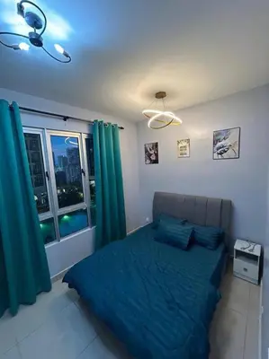 a bedroom with a blue bed and a window at Setapak KL Apt 3 Room 8 pax in Kuala Lumpur