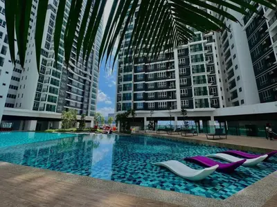 a swimming pool with lounge chairs and buildings at Setapak KL Apt 3 Room 8 pax in Kuala Lumpur