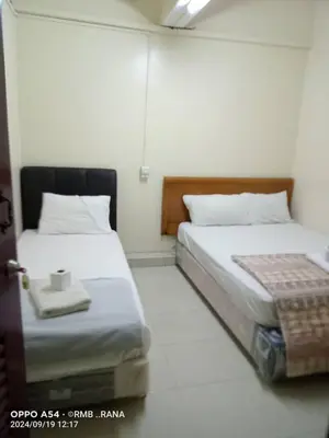 a room with two beds at perfect class hotel in Kuala Lumpur