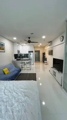 a large living room with a couch and a kitchen at KL City Centre in Kuala Lumpur