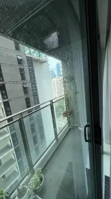 a room with a window with a view of a city at KL City Centre in Kuala Lumpur