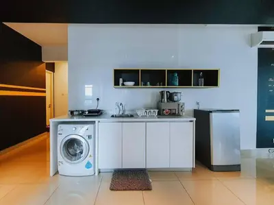 a kitchen with a washer and a washing machine at apartment for classic lover in Kuala Lumpur