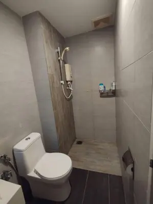 a small bathroom with a toilet and a shower at apartment for classic lover in Kuala Lumpur