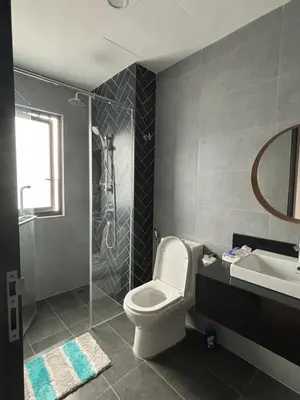 a bathroom with a toilet and a sink and a shower at Modern Luxury Apartment, Sunway, TRX in Kuala Lumpur