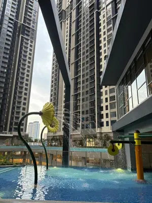 a swimming pool in a city with tall buildings at Modern Luxury Apartment, Sunway, TRX in Kuala Lumpur