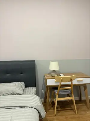 a bedroom with a bed and a desk with a lamp at Modern Luxury Apartment, Sunway, TRX in Kuala Lumpur