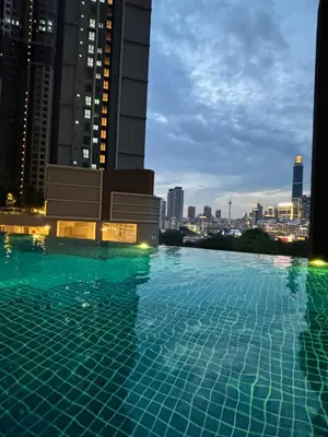 a swimming pool on the roof of a building with a city at Modern Luxury Apartment, Sunway, TRX in Kuala Lumpur