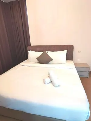 a bedroom with a bed with two towels on it at Swiss Garden Residence by Offex Suites KL in Kuala Lumpur
