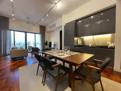 a kitchen and dining room with a table and chairs at The Mews KLCC by PILLOWTALKS in Kuala Lumpur
