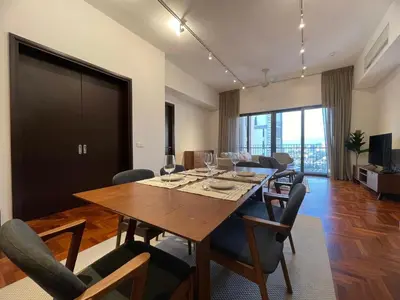 a dining room with a table and chairs at The Mews KLCC by PILLOWTALKS in Kuala Lumpur