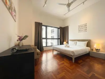 a bedroom with a bed and a television in it at The Mews KLCC by PILLOWTALKS in Kuala Lumpur