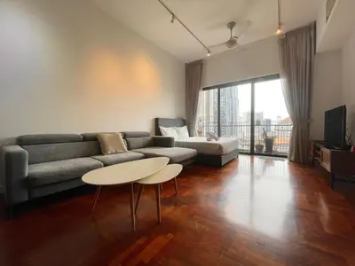 a living room with a couch and a table at The Mews KLCC by PILLOWTALKS in Kuala Lumpur