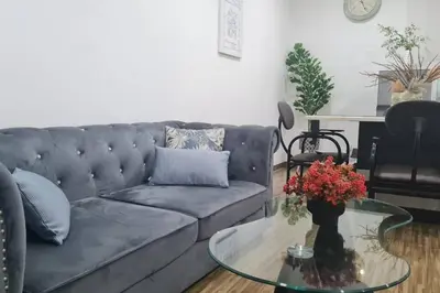 a living room with a couch and a glass table at Cozy studio family lake view SETAPAK CENTRAL MALL in Kuala Lumpur