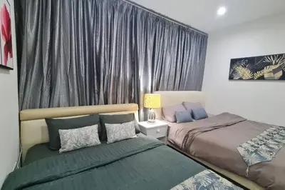 a bedroom with two beds and a window with curtains at Cozy studio family lake view SETAPAK CENTRAL MALL in Kuala Lumpur