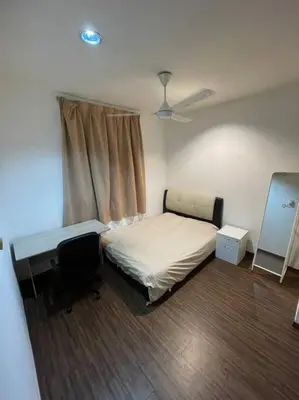 a bedroom with a bed and a desk and a window at Cozy lake view at top of setapak central mall in Kuala Lumpur