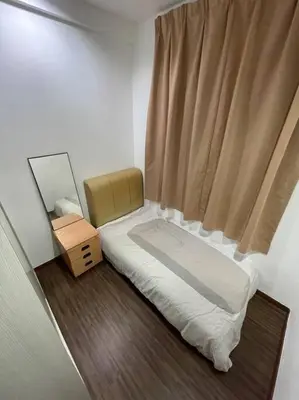 a small bedroom with a bed and a window at Cozy lake view at top of setapak central mall in Kuala Lumpur