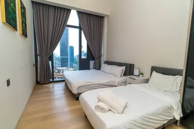 a hotel room with two beds and a window at STAR RESIDENCE KLCC By GANTYA in Kuala Lumpur