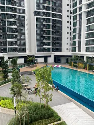 a large swimming pool in a city with tall buildings at RSJ Homestay at Setapak - Studio in Kuala Lumpur