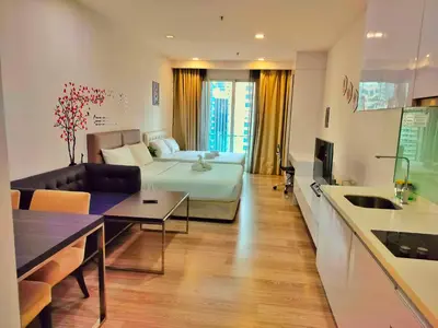 a living room with a bed and a couch and a kitchen at Sky Manor One Bukit Ceylon KLCC in Kuala Lumpur