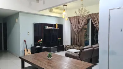 a living room with a table and a guitar at Hostel At Regalia Residence in Kuala Lumpur