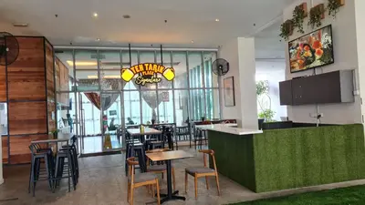 a restaurant with a bar and some tables and chairs at Hostel At Regalia Residence in Kuala Lumpur