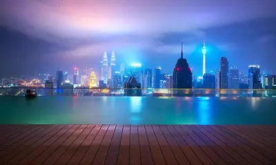 a view of a city skyline at night at Casablanca Skypool Hostel in Kuala Lumpur