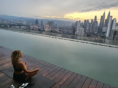 a woman sitting on the edge of a pool of water at Casablanca Skypool Hostel in Kuala Lumpur