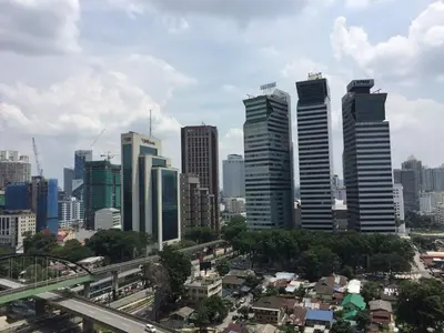 a city skyline with tall buildings and a highway at Bmchomes Mercu summer suite in Kuala Lumpur