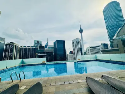 a large swimming pool with a view of the city at SOHO SUITES KLCC by DREAMS in Kuala Lumpur
