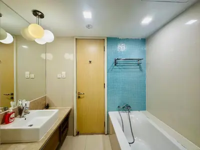 a bathroom with a tub and a sink and a shower at SOHO SUITES KLCC by DREAMS in Kuala Lumpur