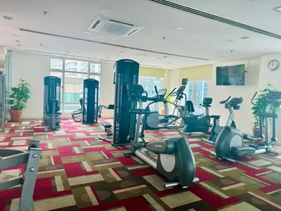 a gym with treadmills and ellipticals in a room at SOHO SUITES KLCC by DREAMS in Kuala Lumpur