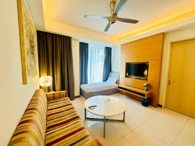 a living room with a couch and a table and a television at SOHO SUITES KLCC by DREAMS in Kuala Lumpur