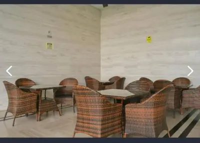 a room with wicker chairs and tables in a room at Golden HeavenHomestay in Kuala Lumpur