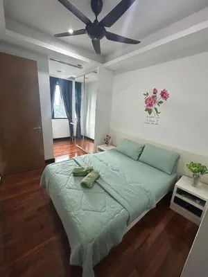a bedroom with a bed with a ceiling fan at Golden HeavenHomestay in Kuala Lumpur