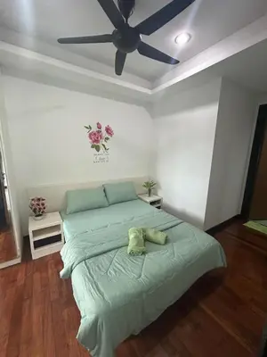a bedroom with a bed with a ceiling fan at Golden HeavenHomestay in Kuala Lumpur