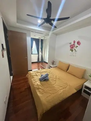 a bedroom with a bed with a ceiling fan at Golden HeavenHomestay in Kuala Lumpur