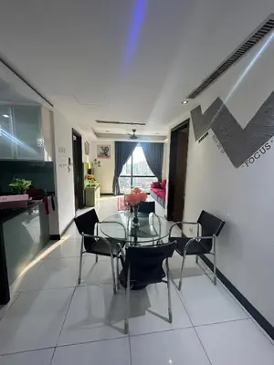 a dining room with a glass table and chairs at Golden HeavenHomestay in Kuala Lumpur