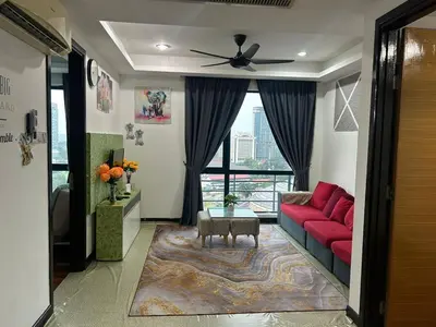 a living room with a red couch and a window at Golden HeavenHomestay in Kuala Lumpur