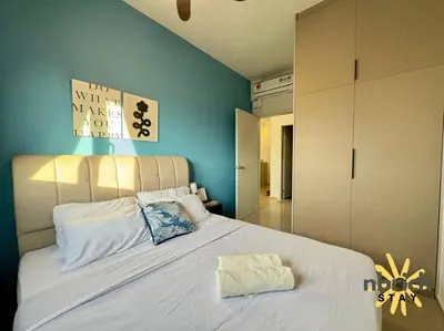 a bedroom with a large white bed with blue walls at Cozy Retreat in the heart of KL by nbrichstay in Kuala Lumpur