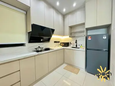 a kitchen with white cabinets and a refrigerator at Cozy Retreat in the heart of KL by nbrichstay in Kuala Lumpur