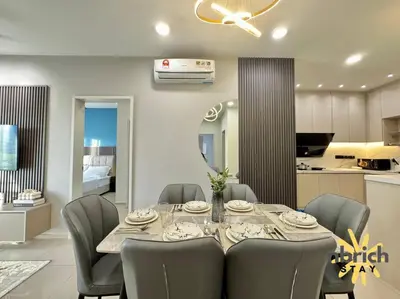 a dining room with a table and chairs and a kitchen at Cozy Retreat in the heart of KL by nbrichstay in Kuala Lumpur
