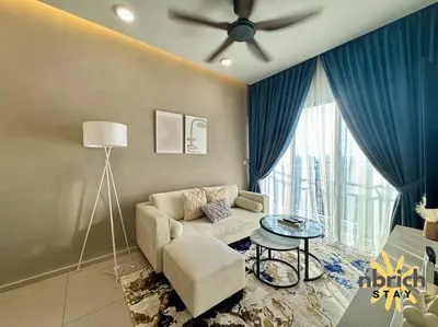 a living room with a couch and a ceiling fan at Cozy Retreat in the heart of KL by nbrichstay in Kuala Lumpur