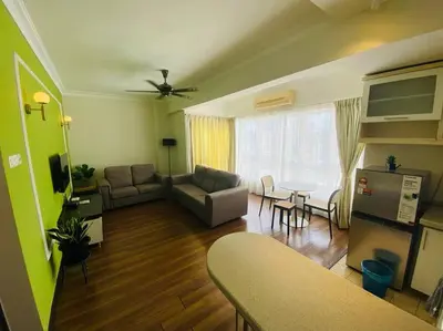 a living room with a couch and a table at Luxury Room Minutes from KLCC in Kuala Lumpur