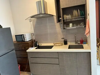 a small kitchen with a sink and a microwave at Tamu Hotel & Suites Stay in Kuala Lumpur
