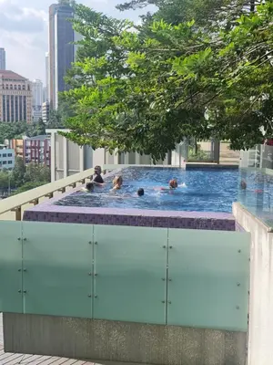a group of people in a swimming pool on a building at The Robertson Residence Kuala Lumpur in Kuala Lumpur