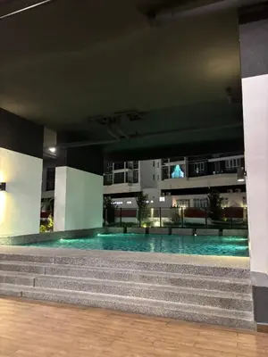 a swimming pool in the middle of a building with stairs at Cozy Homestay KL Setapak 2R2B 1CarPark, Pool, Wifi, MALAYSIAN ONLY & MUS-LIM RECOMMENDED in Kuala Lumpur