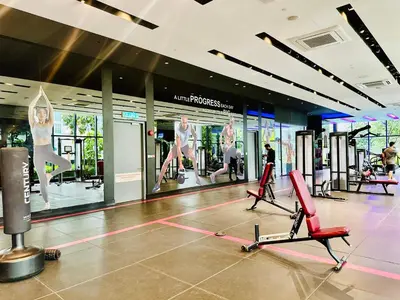 a gym with exercise equipment and people exercising in it at Star Residence KLCC By Starlight in Kuala Lumpur