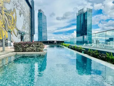 a swimming pool on the roof of a building with tall buildings at Star Residence KLCC By Starlight in Kuala Lumpur