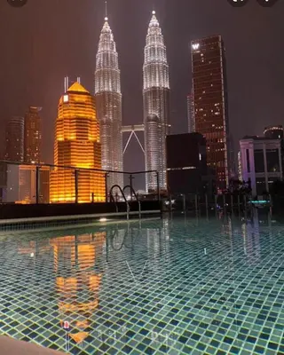 a pool on the roof of a building with a city skyline at Skyhomes KLCC New in Kuala Lumpur